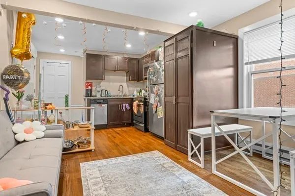 a kitchen with stainless steel appliances kitchen island granite countertop a refrigerator and a stove