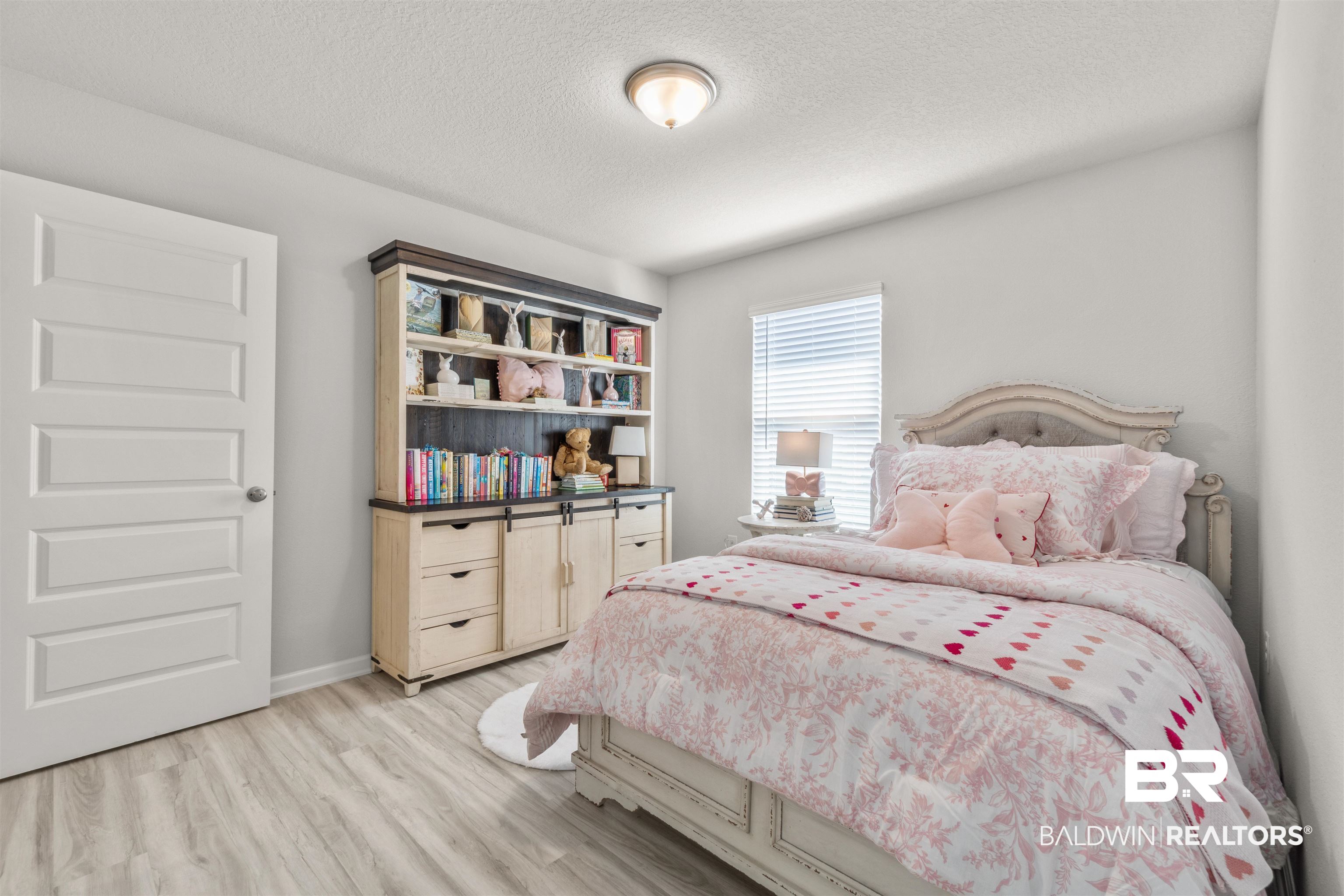 24472 Ringneck Loop Elberta, AL 36530 - Photo 25 of 46 Bedroom with a textured ceiling and light hardwood / wood-style floors