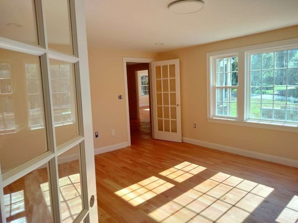 26 Woodleigh Road Dedham, MA 02026 - Photo 13 of 35 a view of an empty room with wooden floor and a window