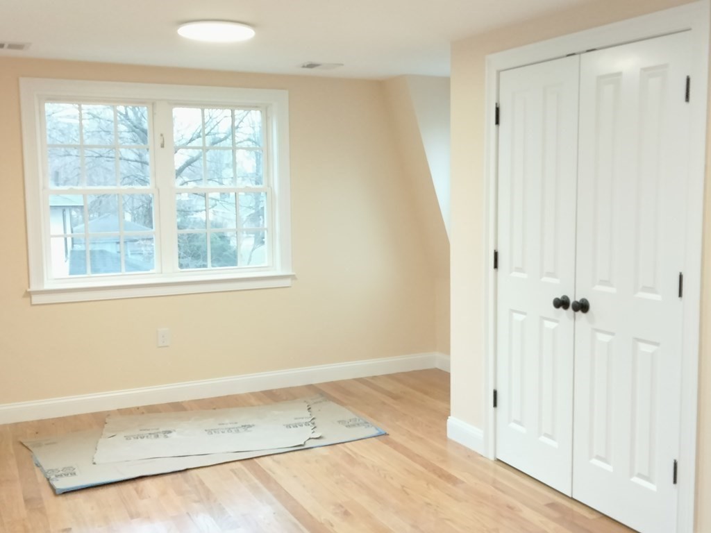 26 Woodleigh Road Dedham, MA 02026 - Photo 24 of 35 an empty room with a window and wooden floor