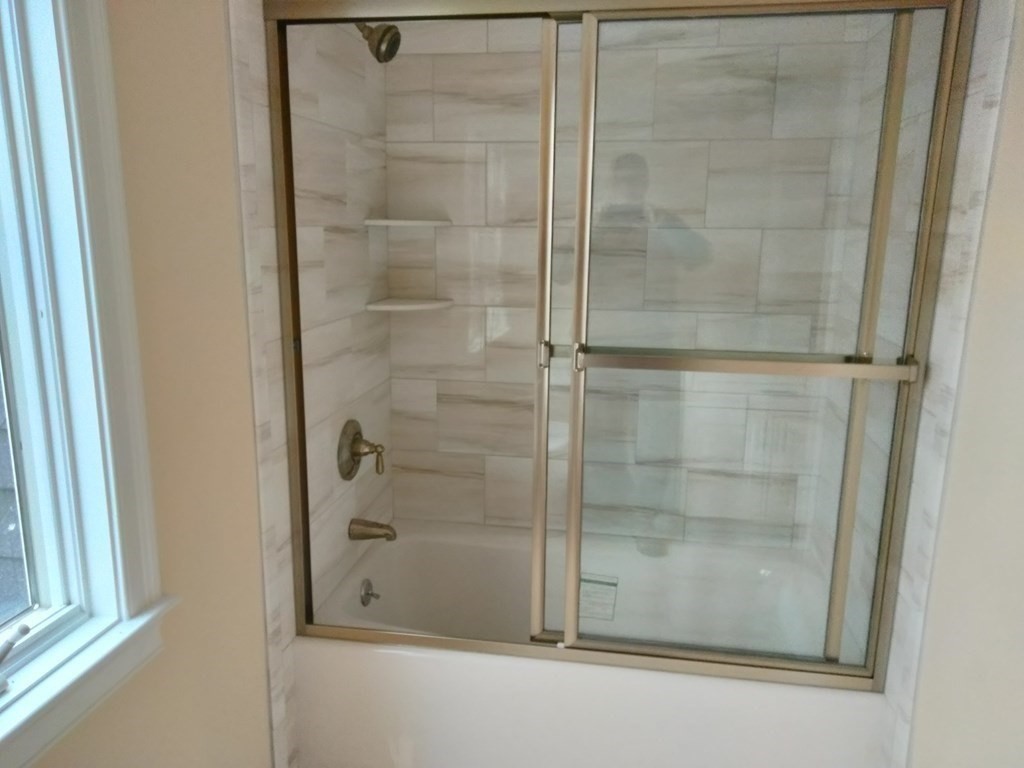 26 Woodleigh Road Dedham, MA 02026 - Photo 27 of 35 a bathroom with a glass shower door