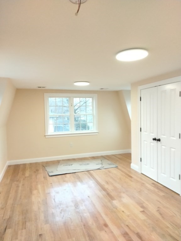 26 Woodleigh Road Dedham, MA 02026 - Photo 28 of 35 wooden floor in an empty room with a window
