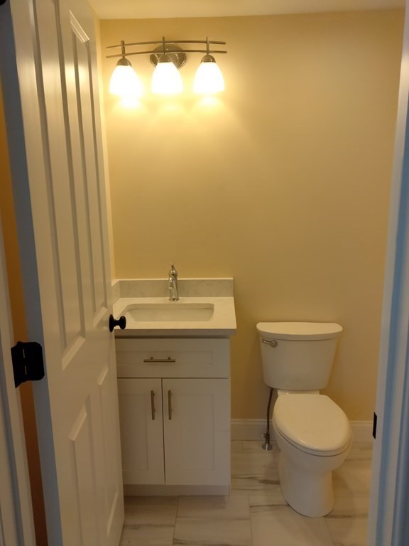 26 Woodleigh Road Dedham, MA 02026 - Photo 34 of 35 a bathroom with a toilet sink and vanity