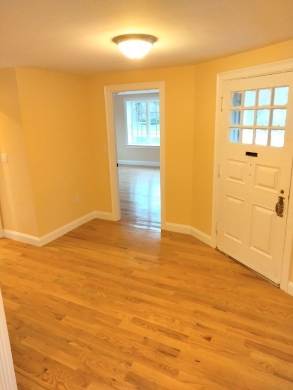 26 Woodleigh Road Dedham, MA 02026 - Photo 5 of 35 a view of empty room with wooden floor and fan