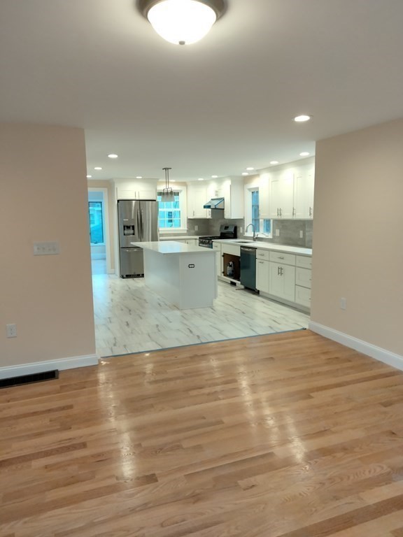 26 Woodleigh Road Dedham, MA 02026 - Photo 7 of 35 a view of kitchen and hall with wooden floor