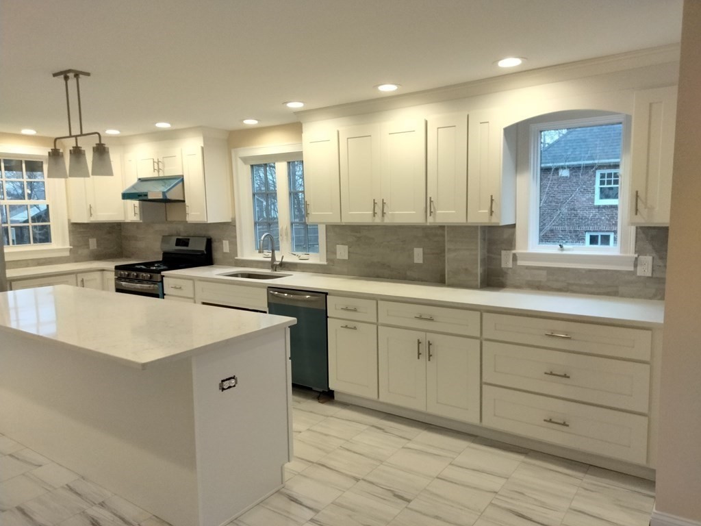 26 Woodleigh Road Dedham, MA 02026 - Photo 9 of 35 a kitchen with a sink stove and cabinets