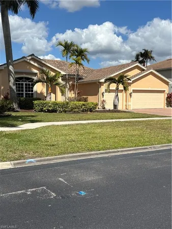 a front view of a house with a yard and a garage