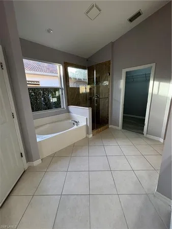 a large white kitchen with a sink a microwave and cabinets