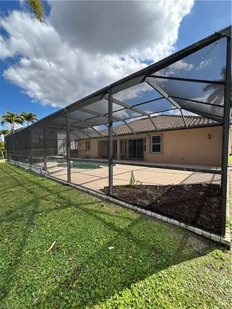 a room with pool table and windows