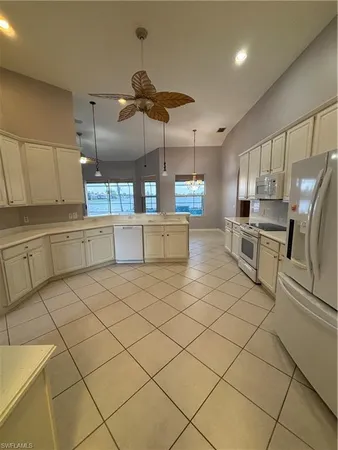 a kitchen with stainless steel appliances a refrigerator and a stove top oven