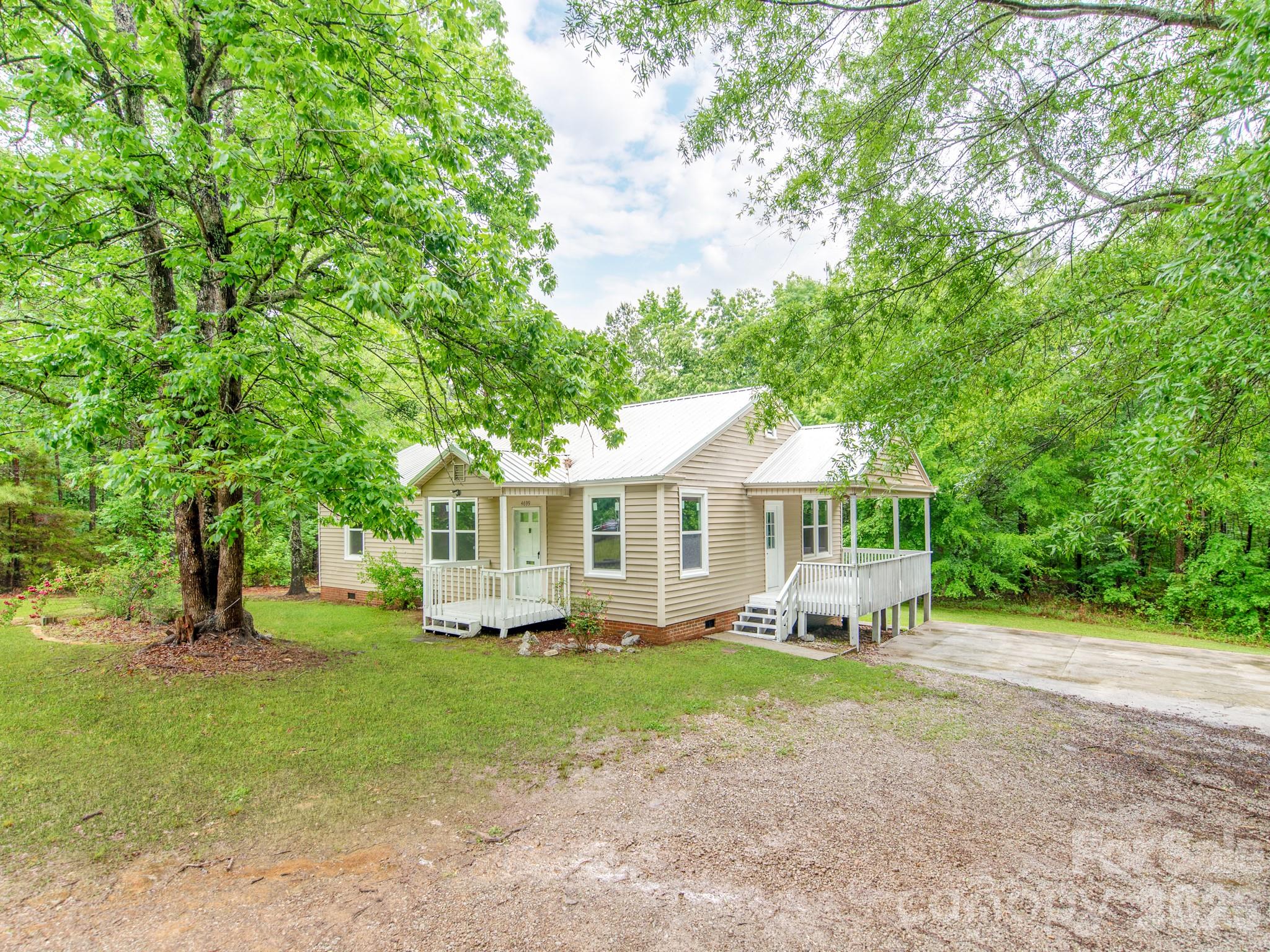 4699 Cherrystone Road Lancaster, SC 29720 - Photo 24 of 28 a front view of a house with a garden and trees