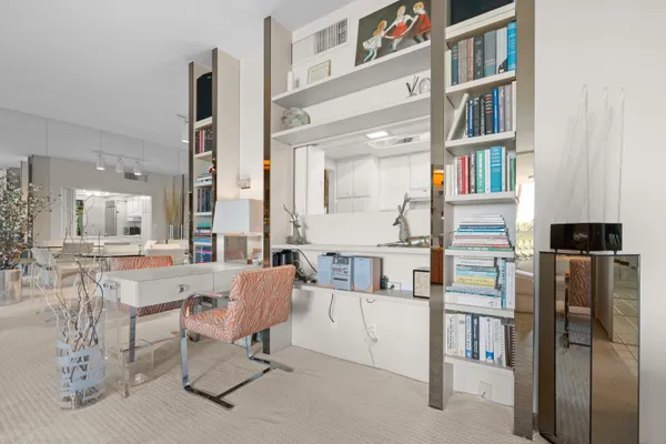 a bedroom with a bed and glass walk in closet