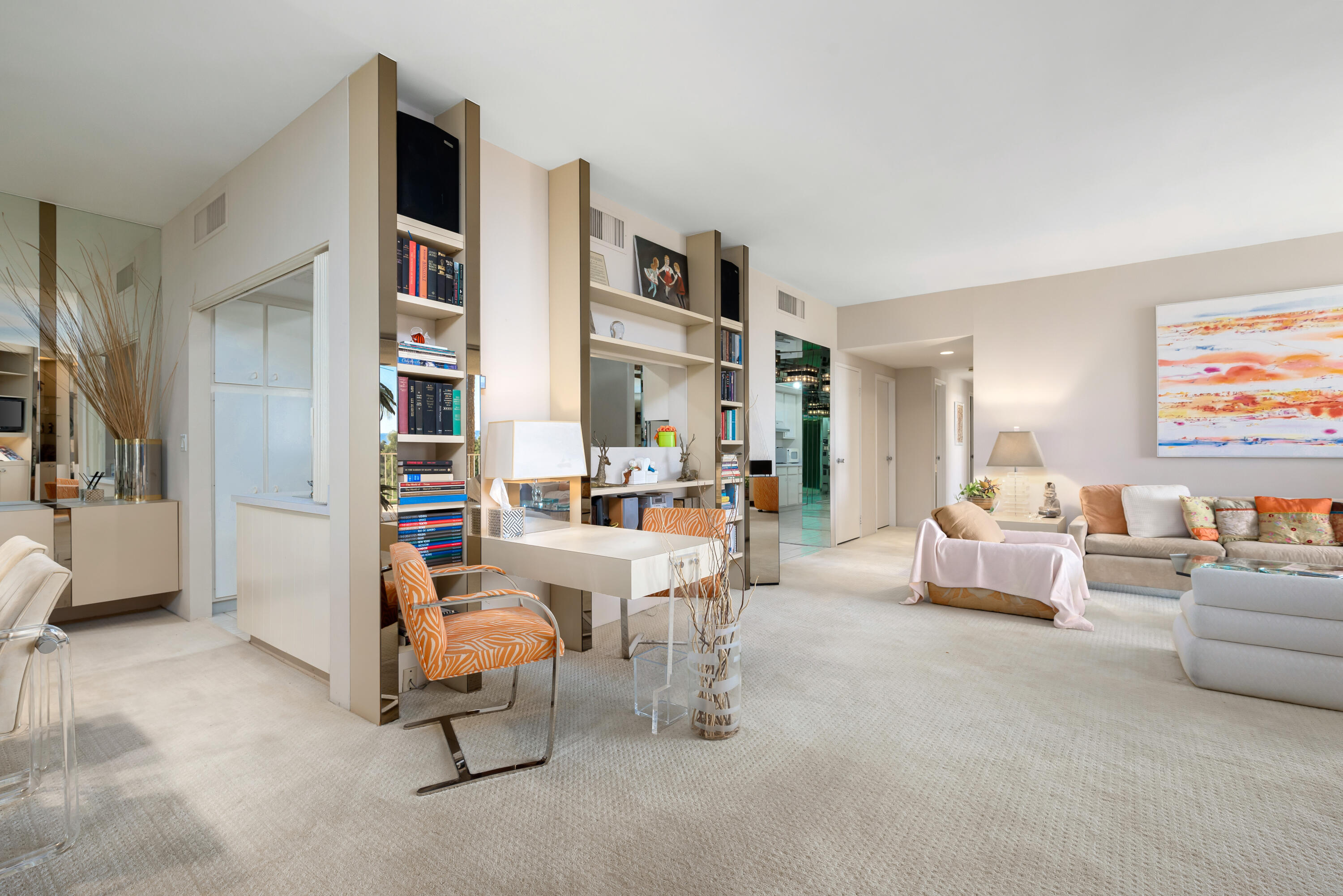 900 Island Drive, Unit 507 Rancho Mirage, CA 92270 - Photo 23 of 37 a living room with furniture and a book shelf