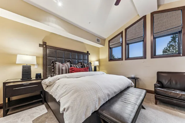 a bedroom with a bed and a night stand