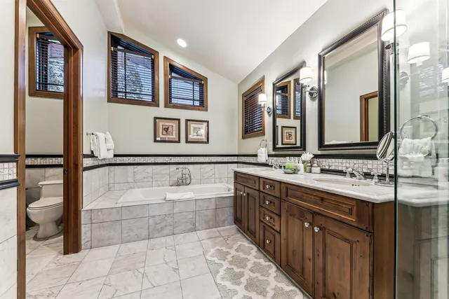 a spacious bathroom with a bathtub sink and mirror