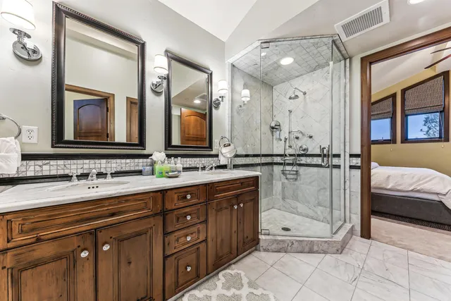 a spacious bathroom with a double vanity sink and a mirror