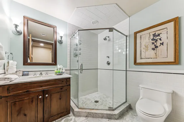 a bathroom with a sink a toilet and shower