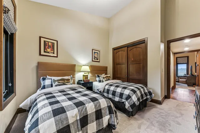 a bedroom with two beds and a lamp