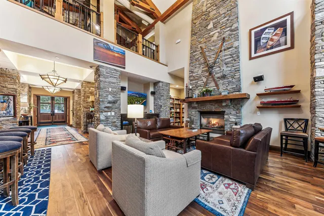 a living room with furniture large window and a fireplace