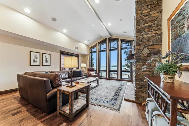 a living room with furniture a table and a potted plant