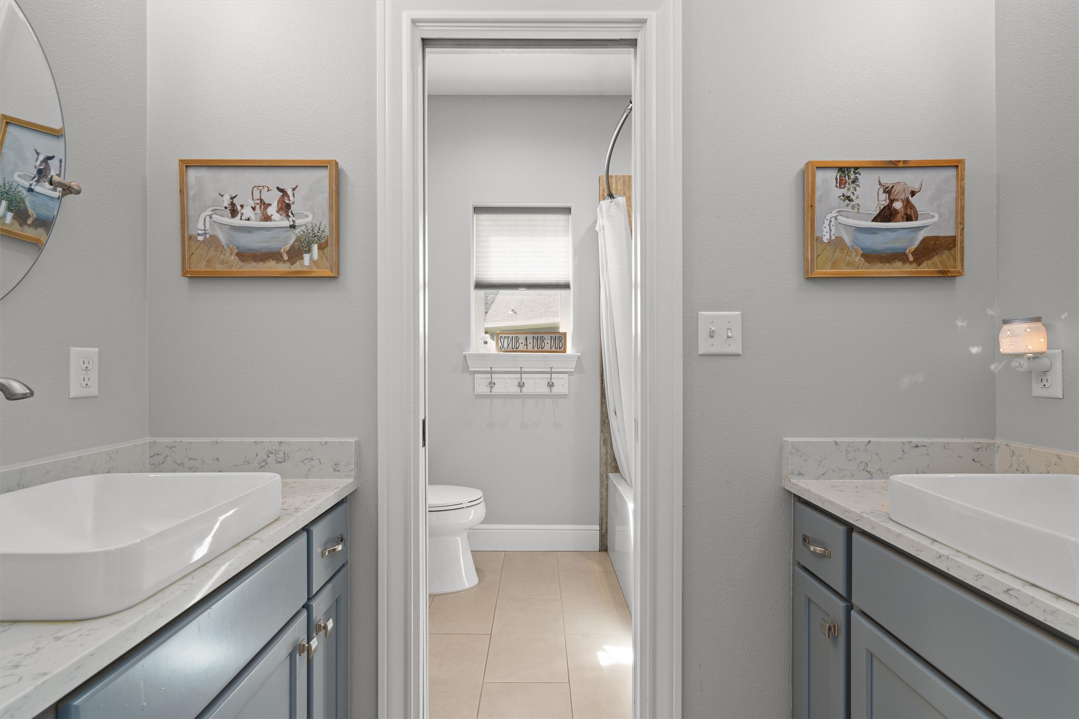 136 Fawn Hollow Elgin, TX 78621 - Photo 25 of 40 Dual vessel sinks set atop quartz countertops with matte gray cabinetry