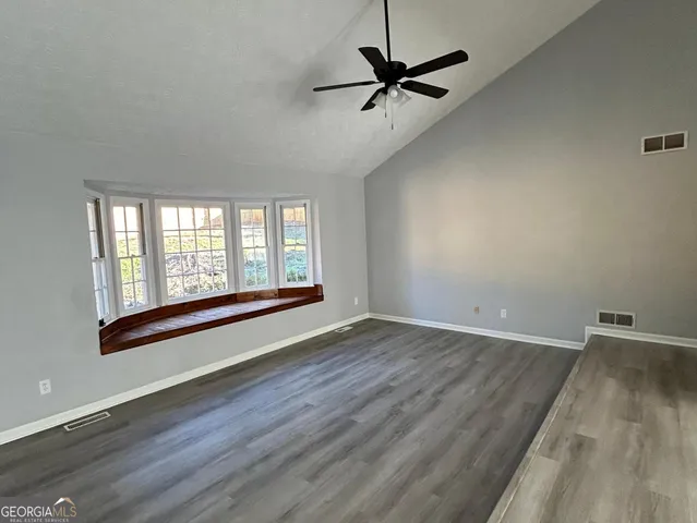wooden floor in an empty room with a window