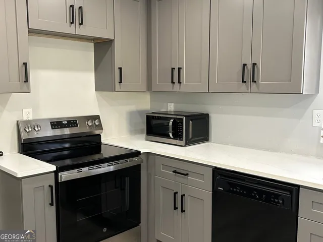 a kitchen with a stove and a microwave