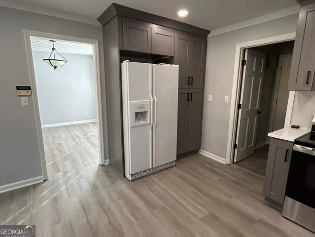 a view of a refrigerator in kitchen and wooden floor