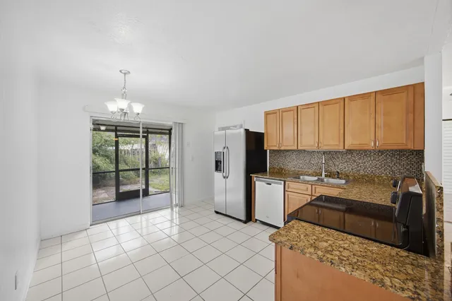 a kitchen with a sink cabinets and appliances