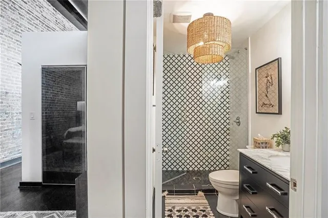 a bathroom with a sink toilet and shower