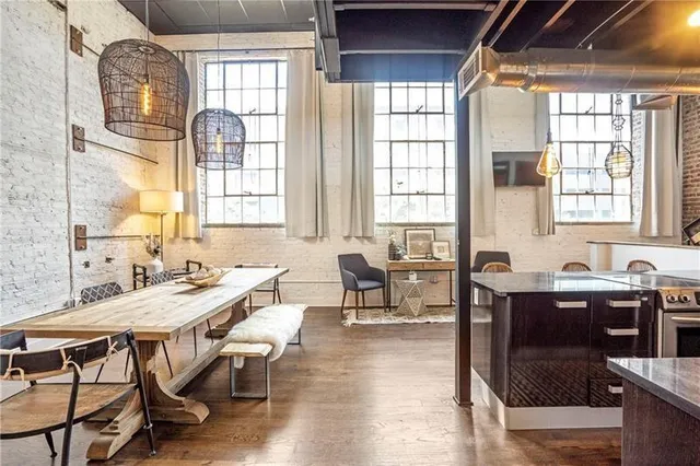 a view of a a dining room with furniture window and wooden floor
