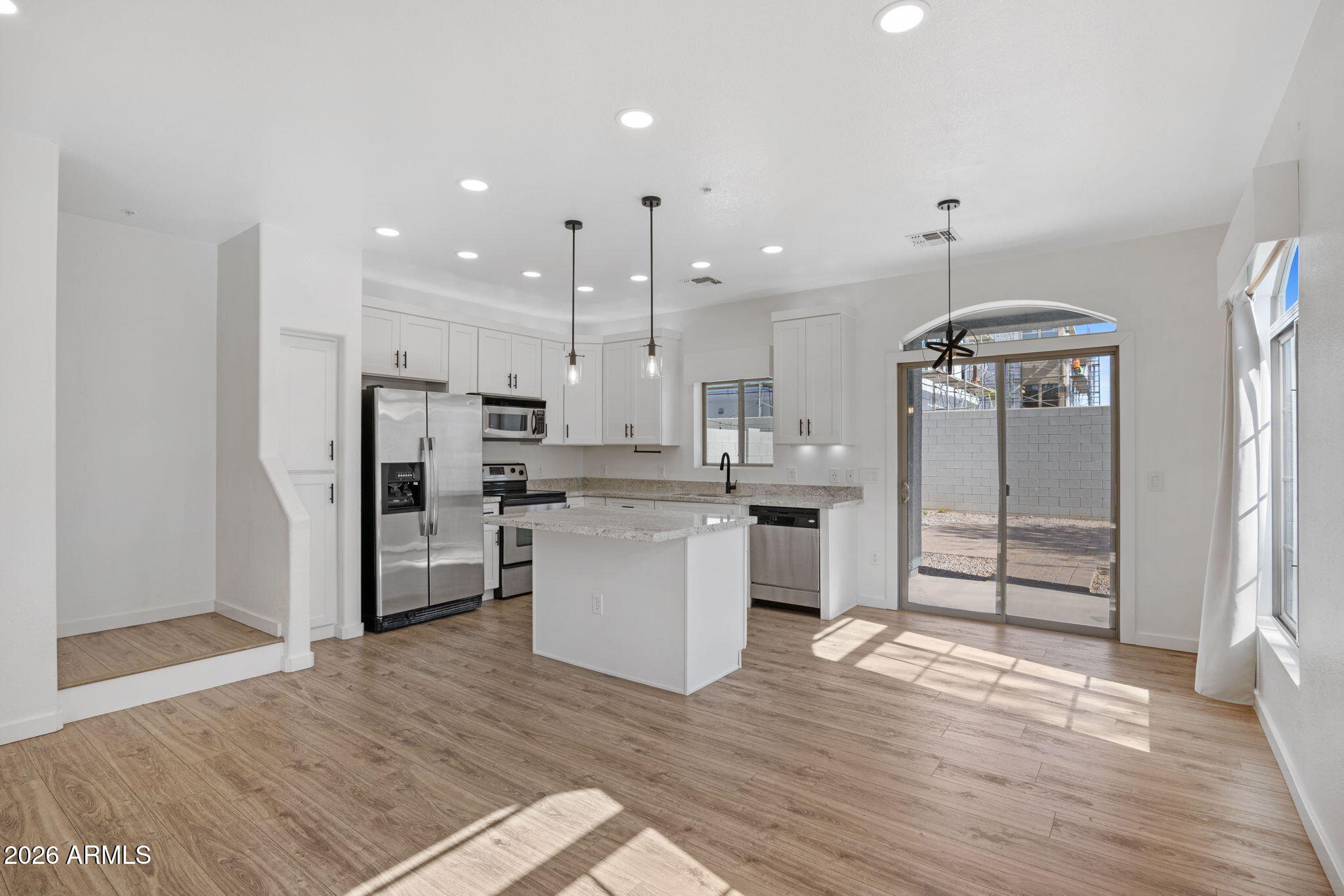 280 South Evergreen Road, Unit 1368 Tempe, AZ 85288 - Photo 11 of 42 a kitchen with stainless steel appliances kitchen island granite countertop a refrigerator and cabinets