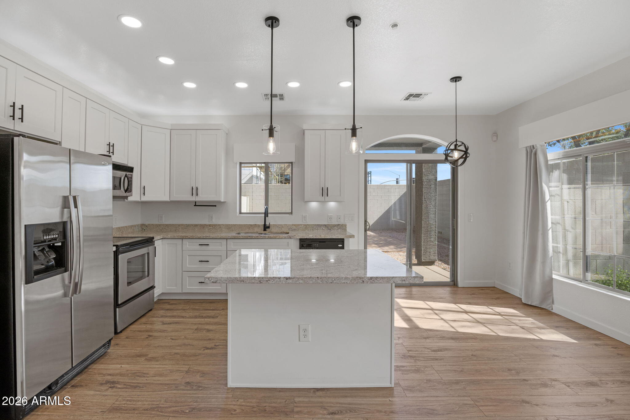 280 South Evergreen Road, Unit 1368 Tempe, AZ 85288 - Photo 12 of 42 a kitchen with kitchen island a counter top space a sink appliances and cabinets