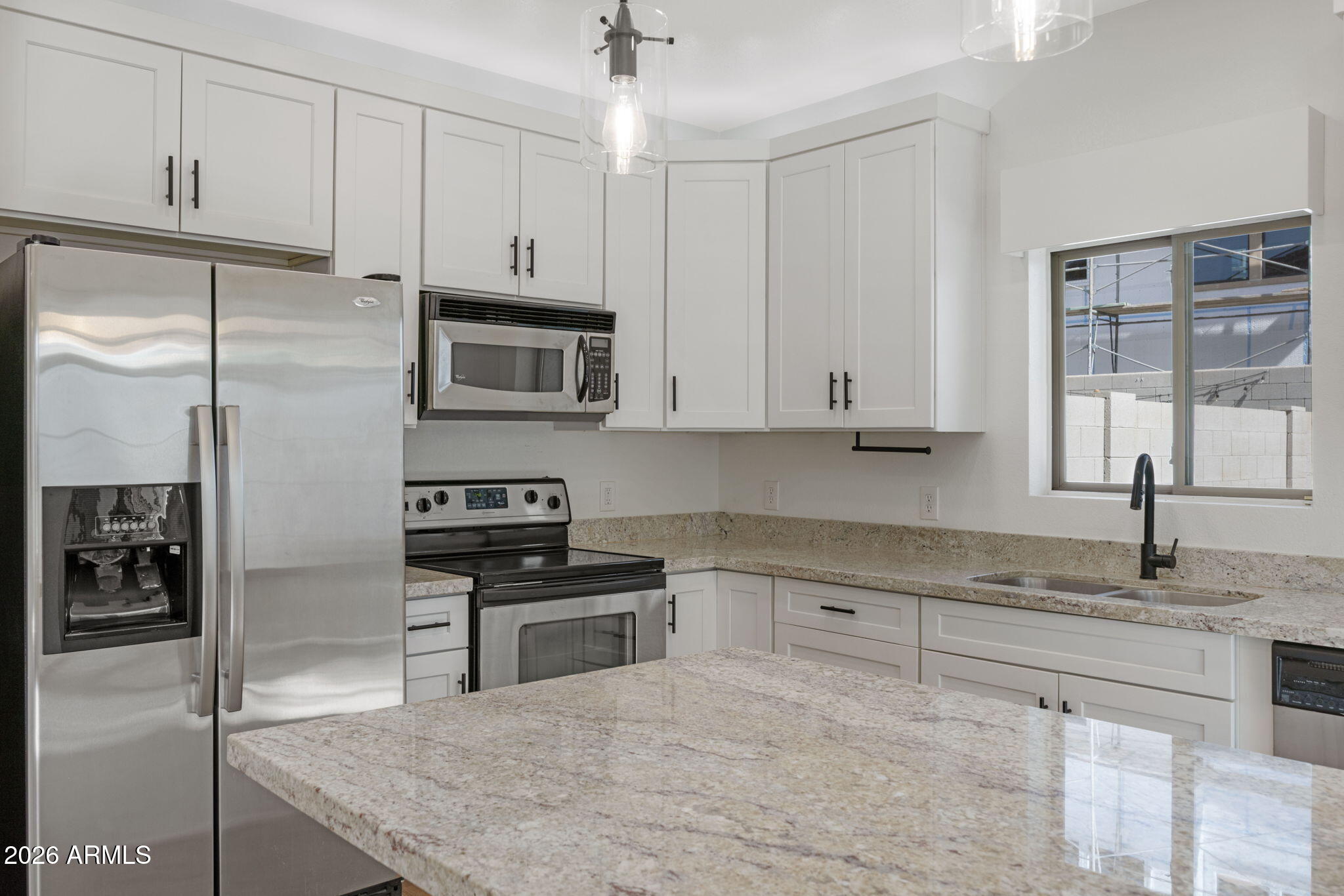 280 South Evergreen Road, Unit 1368 Tempe, AZ 85288 - Photo 14 of 42 a kitchen with granite countertop a stove a sink and a refrigerator