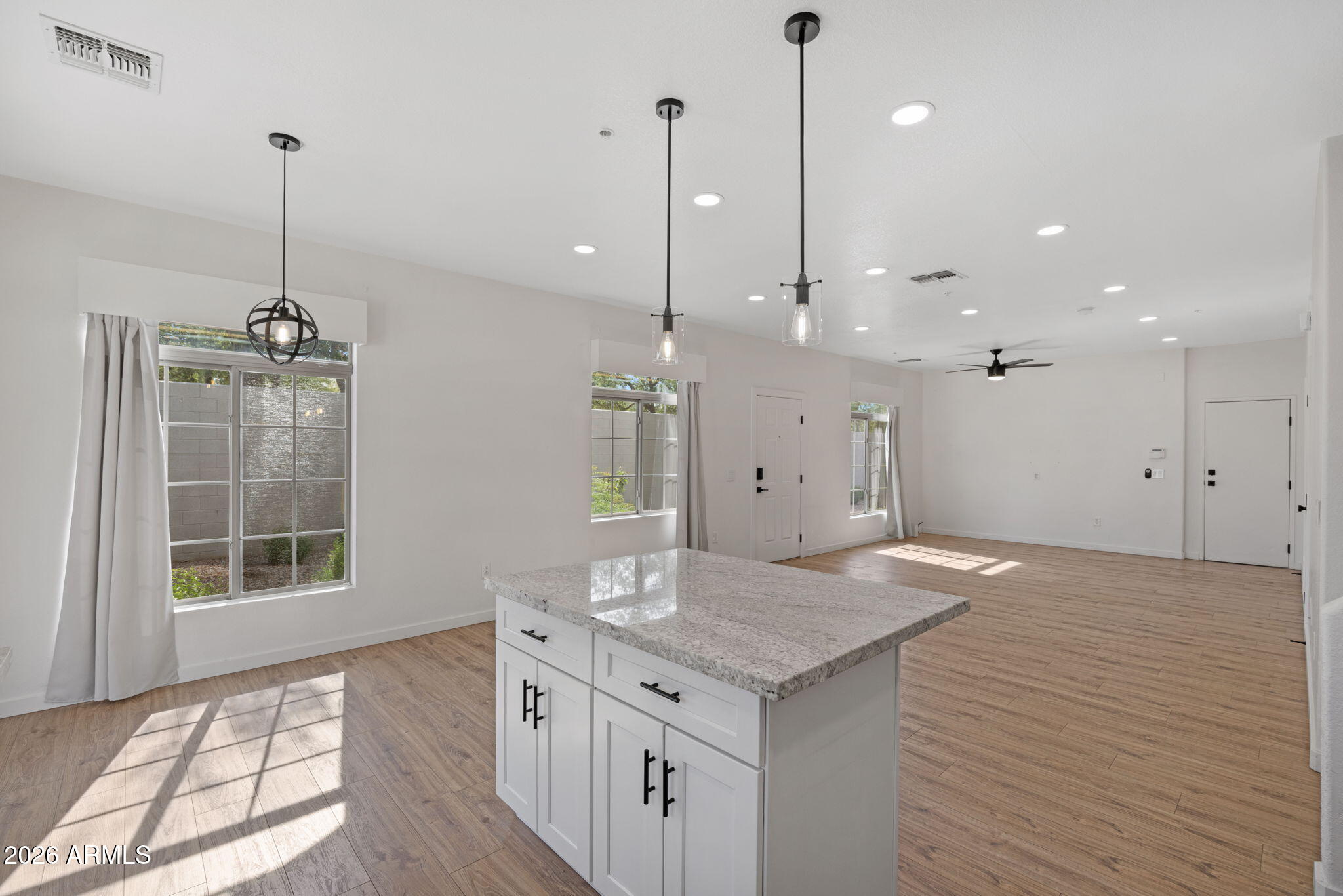 280 South Evergreen Road, Unit 1368 Tempe, AZ 85288 - Photo 16 of 42 a kitchen with a sink chandelier and wooden floor