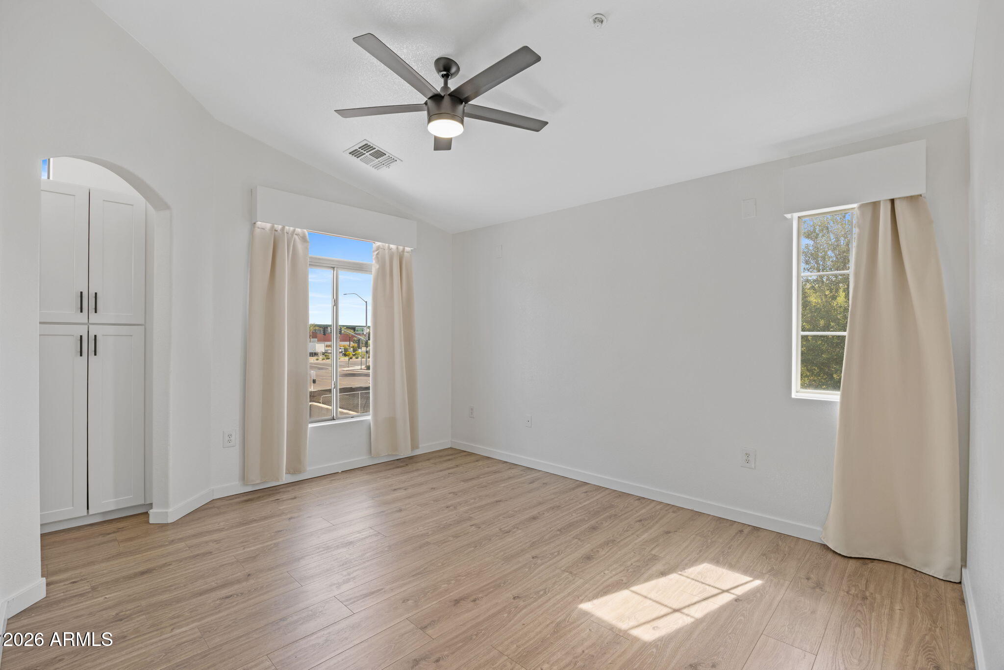 280 South Evergreen Road, Unit 1368 Tempe, AZ 85288 - Photo 24 of 42 an empty room with wooden floor and windows