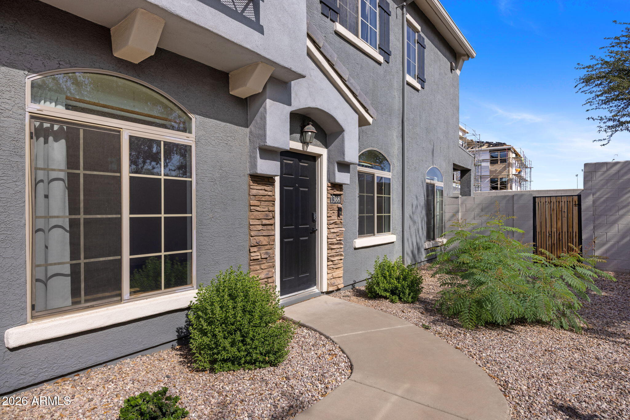280 South Evergreen Road, Unit 1368 Tempe, AZ 85288 - Photo 2 of 42 a front view of a house with a yard