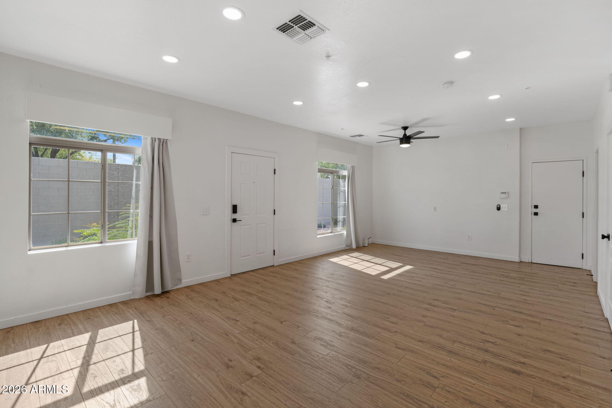 280 South Evergreen Road, Unit 1368 Tempe, AZ 85288 - Photo 4 of 42 a view of empty room with wooden floor and fan