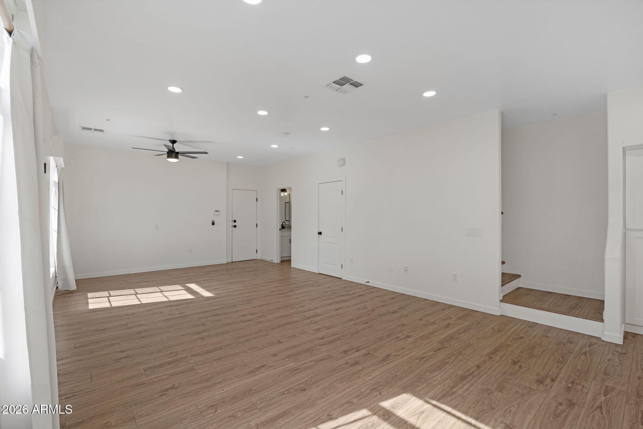 280 South Evergreen Road, Unit 1368 Tempe, AZ 85288 - Photo 6 of 42 an empty room with wooden floor and windows