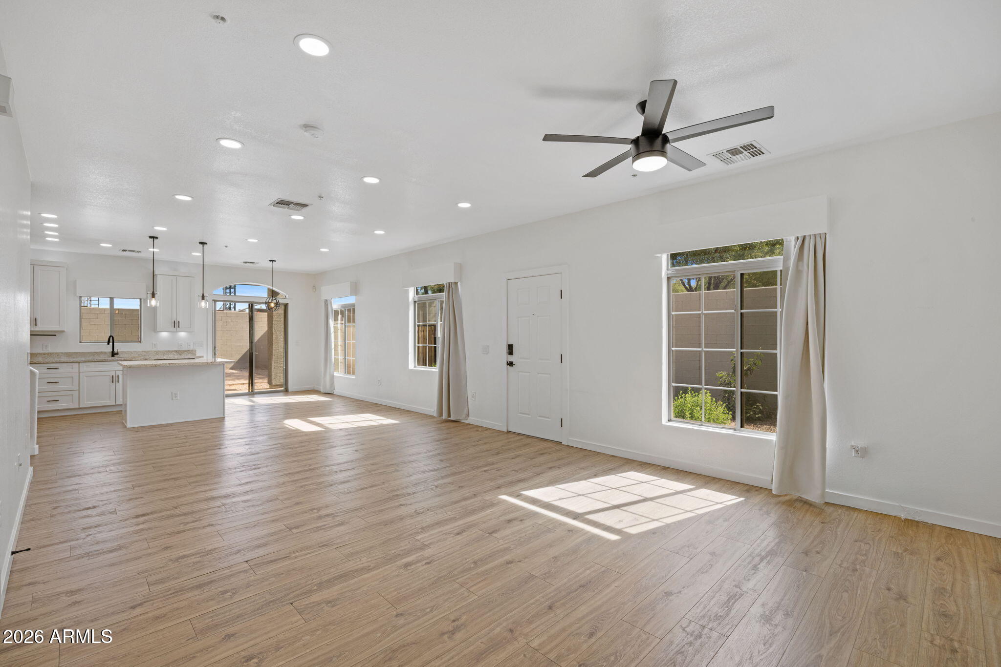 280 South Evergreen Road, Unit 1368 Tempe, AZ 85288 - Photo 7 of 42 a view of an empty room with a window and wooden floor