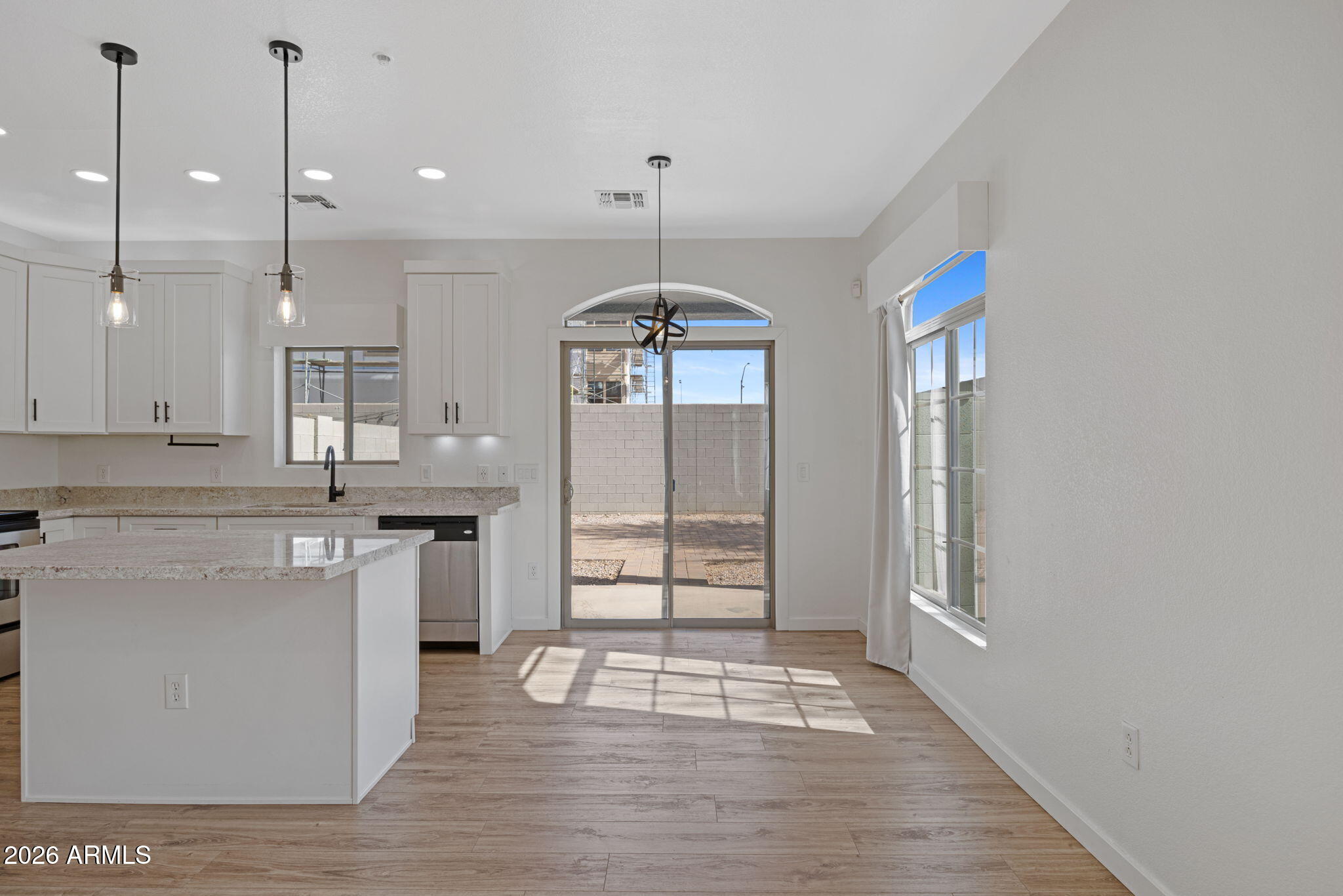 280 South Evergreen Road, Unit 1368 Tempe, AZ 85288 - Photo 9 of 42 a kitchen with stainless steel appliances granite countertop a stove a sink and white cabinets with wooden floor