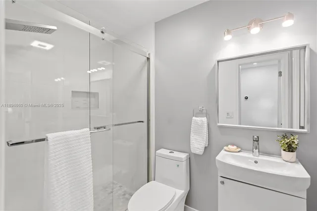 a bathroom with a toilet sink and shower