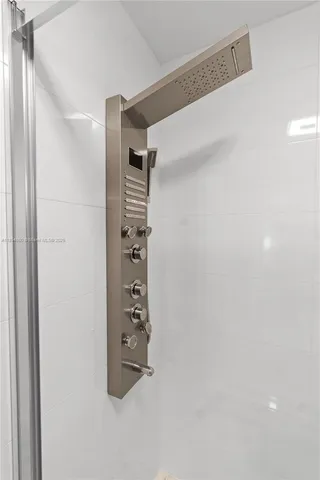 a view of walk in closet with clothes