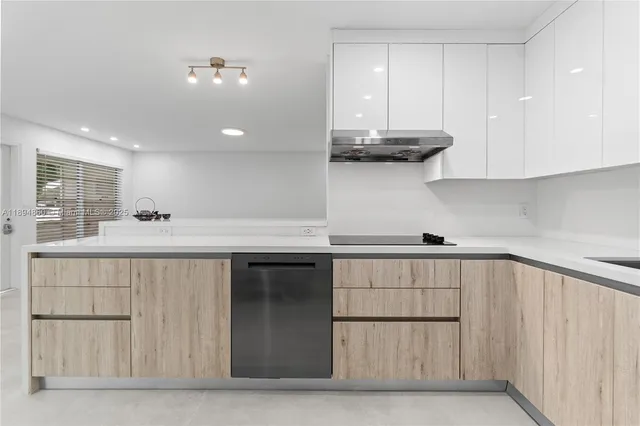 a kitchen with a sink and cabinets