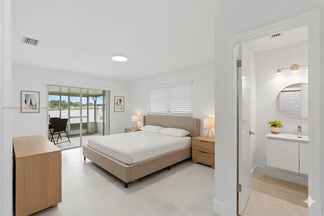 a bedroom with a bed couch and a window