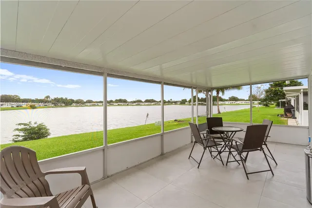 a view of a chairs and table in patio with a lake view