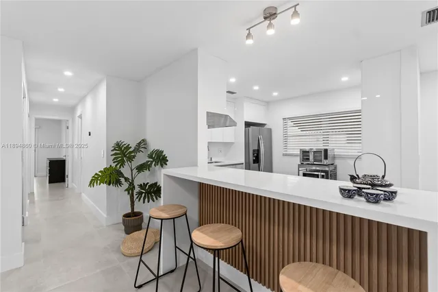 a kitchen with a table and chairs in it