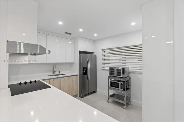 a kitchen with a sink stainless steel appliances and cabinets