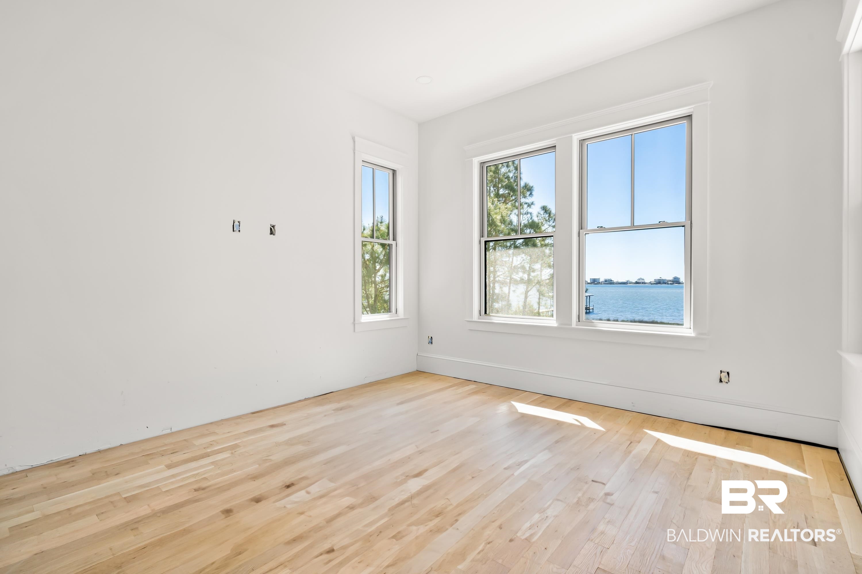 14686 State Highway Gulf Shores, AL 36542 - Photo 25 of 44 Unfurnished room featuring a water view and wood finished floors