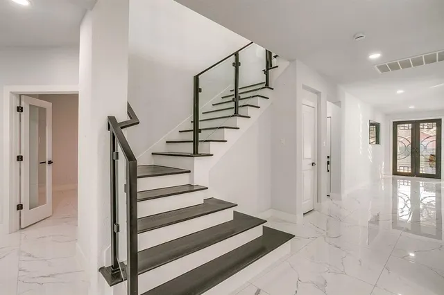 a kitchen with white cabinets and a sink